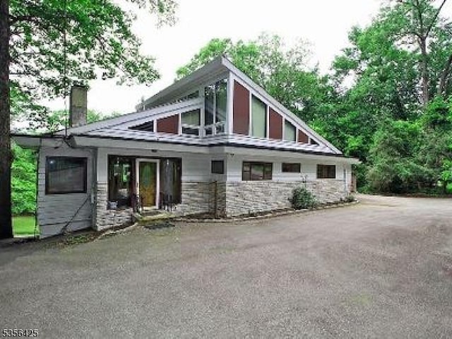 297 Terhune Dr, Wayne Twp, NJ 07470 - rear view of property featuring a chimney and stone siding