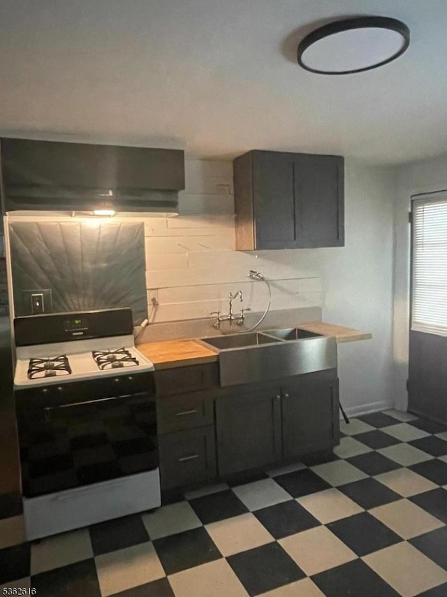 297 Terhune Dr, Wayne Twp, NJ 07470 - kitchen with gas stove, ventilation hood, dark flooring, and light countertops