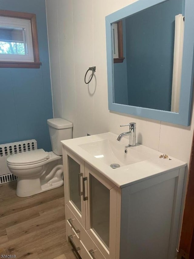 297 Terhune Dr, Wayne Twp, NJ 07470 - half bathroom with vanity, wood finished floors, and a decorative wall