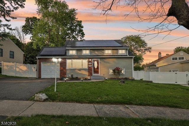 63 Hillsdale Rd, East Brunswick Twp, NJ 08816 - traditional home featuring a garage, roof mounted solar panels, a gate, and asphalt driveway