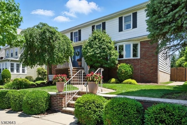 80 Rose St, Wood-Ridge Boro, NJ 07075 - view of front of property featuring brick siding, stairs, and a front yard