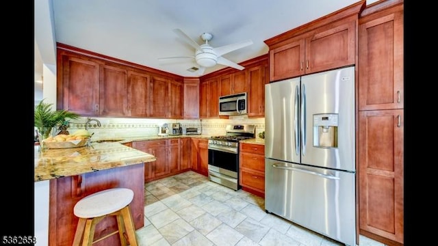 8 Clark Ct, Bernards Twp, NJ 07920 - kitchen featuring appliances with stainless steel finishes, light stone counters, a peninsula, backsplash, and a ceiling fan