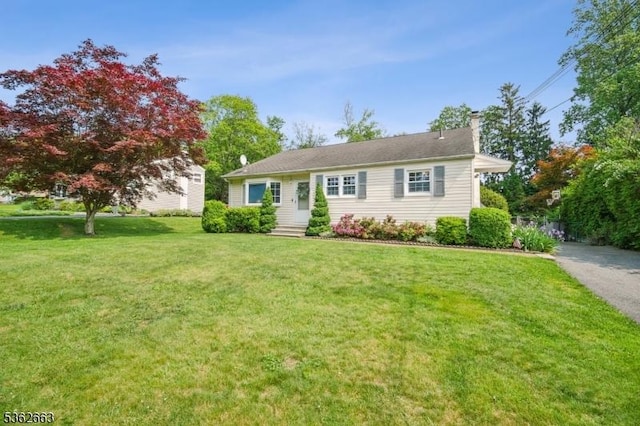 22 Corwin St, Randolph Twp, NJ 07869 - view of front of house with a chimney and a front lawn