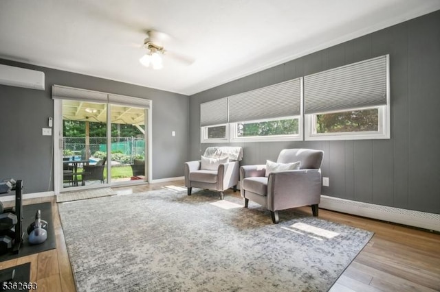 22 Corwin St, Randolph Twp, NJ 07869 - living area with wood finished floors, ceiling fan, a wall mounted AC, and baseboards