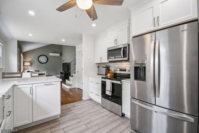 22 Corwin St, Randolph Twp, NJ 07869 - kitchen with appliances with stainless steel finishes, light countertops, light wood-type flooring, ceiling fan, and backsplash