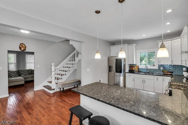 146 Williamson Ave, Hillside Twp, NJ 07205 - kitchen featuring stainless steel fridge, a sink, decorative backsplash, a peninsula, and decorative light fixtures