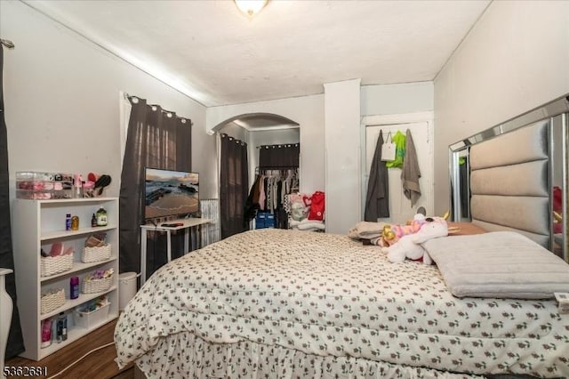141 Berckman St, Plainfield City, NJ 07062 - bedroom with arched walkways, a closet, and wood finished floors