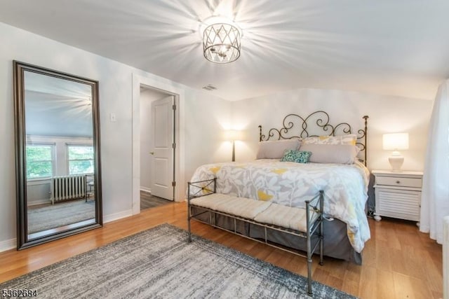 44 Lincoln Ave, Livingston Twp, NJ 07039 - bedroom featuring wood finished floors, baseboards, radiator heating unit, and a chandelier
