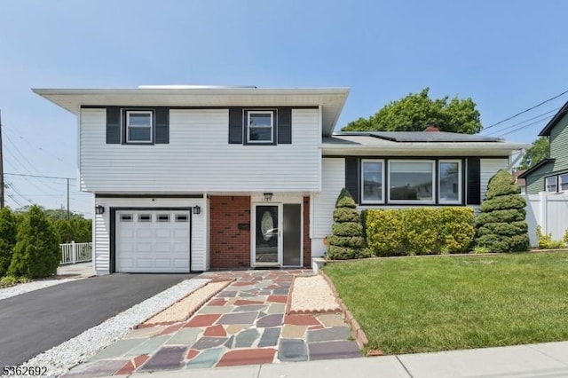1589 Julian Ter, Union Twp, NJ 07083 - tri-level home with asphalt driveway, an attached garage, roof mounted solar panels, and brick siding