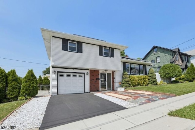 1589 Julian Ter, Union Twp, NJ 07083 - split level home with a garage, asphalt driveway, and brick siding