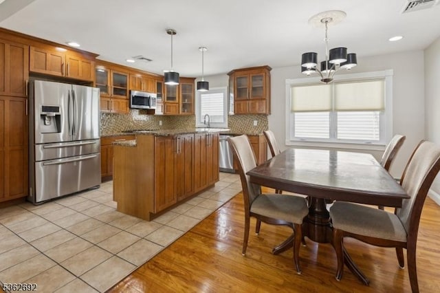 1589 Julian Ter, Union Twp, NJ 07083 - kitchen with appliances with stainless steel finishes, brown cabinets, a chandelier, tasteful backsplash, and recessed lighting