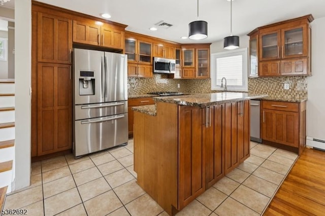 1589 Julian Ter, Union Twp, NJ 07083 - kitchen with appliances with stainless steel finishes, brown cabinetry, plenty of natural light, a center island, and recessed lighting