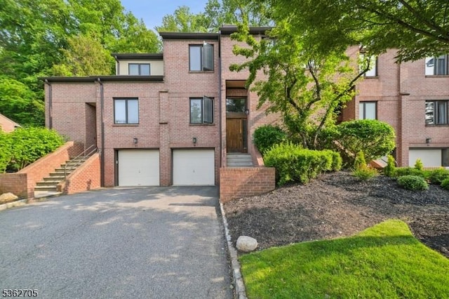 30 Andrea Dr Unit 30, North Caldwell Boro, NJ 07006 - view of front of home with asphalt driveway, brick siding, an attached garage, and stairs