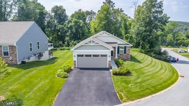 49 Coventry Rd, Hardyston Twp, NJ 07419 - craftsman house with stone siding, driveway, a front yard, an attached garage, and view of scattered trees