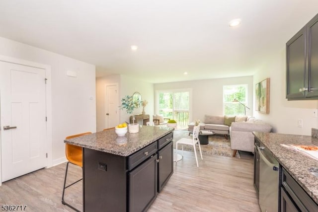 49 Coventry Rd, Hardyston Twp, NJ 07419 - kitchen with a breakfast bar area, dishwasher, light wood finished floors, a kitchen island, and light stone countertops