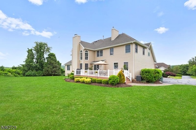 2 Skyview Dr, Sparta Twp, NJ 07871 - back of property with a lawn, a chimney, a deck, and central AC unit
