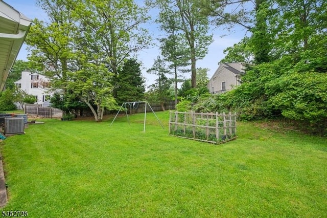61 Joanna Way, Millburn Twp, NJ 07078 - view of yard featuring central AC unit, a garden, and a playground