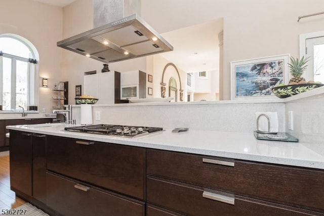 27 Mare Haven Ct, North Brunswick Twp, NJ 08902 - kitchen with ventilation hood, stainless steel gas stovetop, dark brown cabinets, light countertops, and a sink
