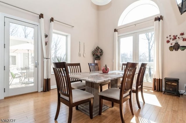 27 Mare Haven Ct, North Brunswick Twp, NJ 08902 - dining space with light wood finished floors, a wood stove, and french doors