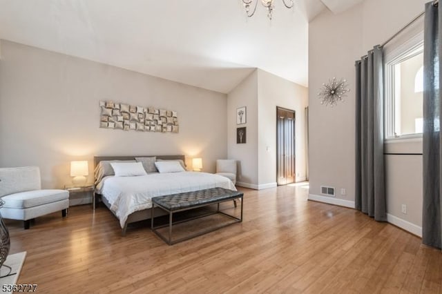 27 Mare Haven Ct, North Brunswick Twp, NJ 08902 - bedroom featuring a chandelier, light wood finished floors, baseboards, and a towering ceiling