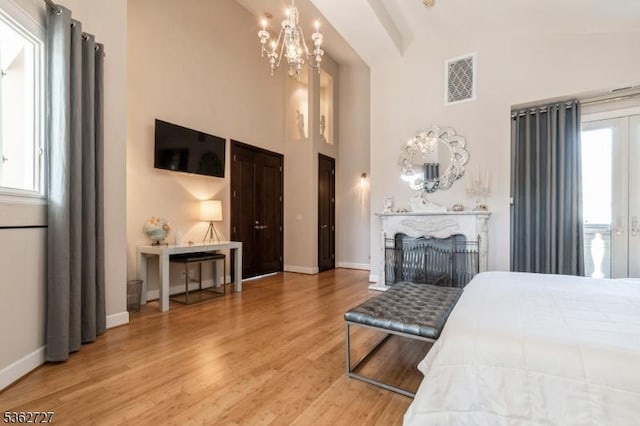 27 Mare Haven Ct, North Brunswick Twp, NJ 08902 - bedroom featuring a chandelier, wood finished floors, baseboards, and a high ceiling