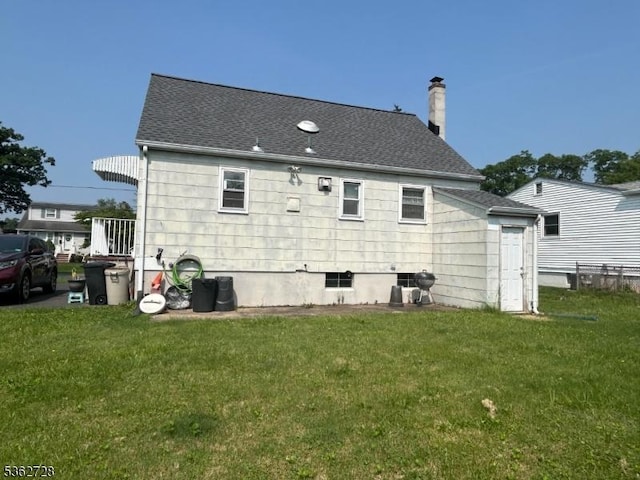 130 2nd St, Middlesex Boro, NJ 08846 - rear view of property featuring a lawn, a chimney, and roof with shingles