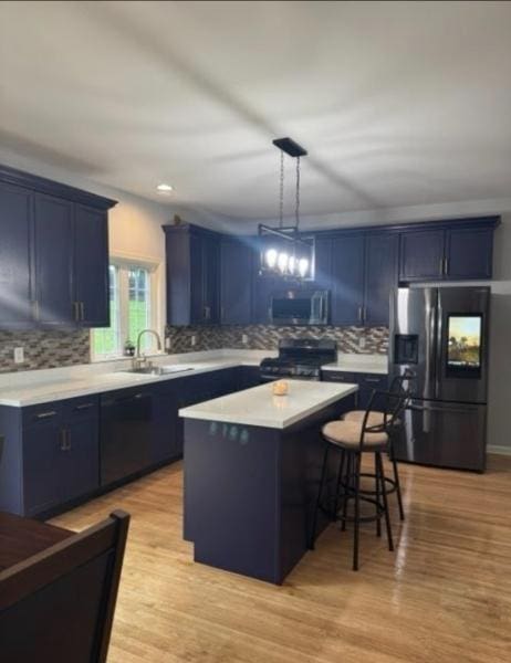 522 Stanhope Rd, Byram Twp, NJ 07871 - kitchen featuring refrigerator with ice dispenser, blue cabinets, range, a center island, and backsplash