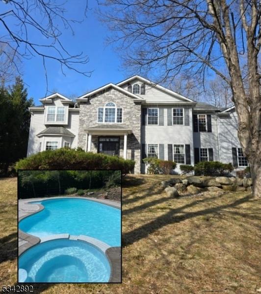 522 Stanhope Rd, Byram Twp, NJ 07871 - rear view of house featuring a pool with connected hot tub and stone siding