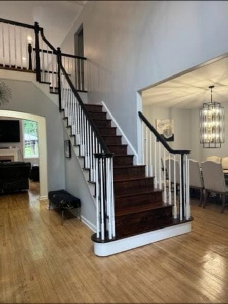 522 Stanhope Rd, Byram Twp, NJ 07871 - staircase featuring a high ceiling, wood finished floors, and a chandelier