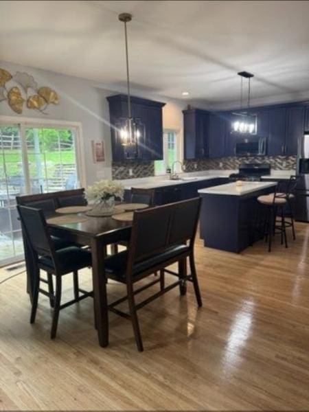 522 Stanhope Rd, Byram Twp, NJ 07871 - dining space with light wood-style flooring and a chandelier