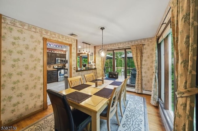 19 Paderewski Rd, Jefferson Twp, NJ 07438 - dining room featuring wallpapered walls, light wood-style flooring, baseboards, and a baseboard heating unit