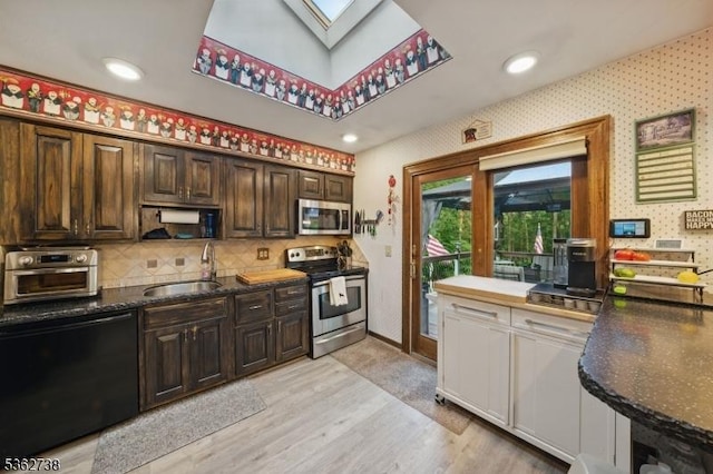 19 Paderewski Rd, Jefferson Twp, NJ 07438 - kitchen featuring appliances with stainless steel finishes, a sink, light wood-style floors, a skylight, and dark brown cabinets