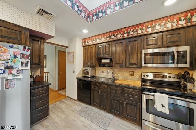 19 Paderewski Rd, Jefferson Twp, NJ 07438 - kitchen featuring stainless steel appliances, a sink, light wood-style floors, tasteful backsplash, and dark brown cabinets