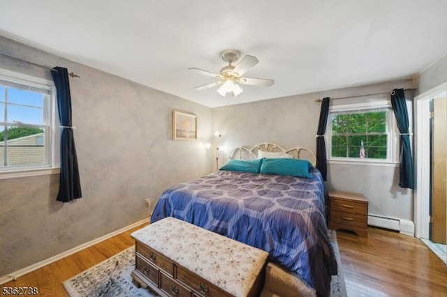 19 Paderewski Rd, Jefferson Twp, NJ 07438 - bedroom featuring a baseboard radiator, wood finished floors, multiple windows, and baseboards