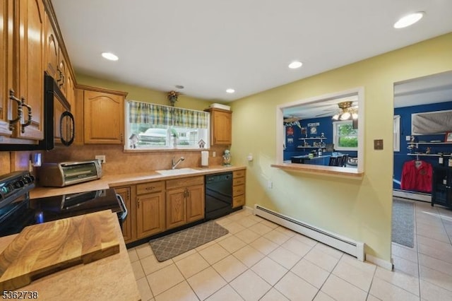 19 Paderewski Rd, Jefferson Twp, NJ 07438 - kitchen with black appliances, baseboard heating, light countertops, light tile patterned floors, and plenty of natural light