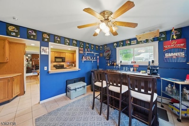 19 Paderewski Rd, Jefferson Twp, NJ 07438 - bar area featuring black microwave, light tile patterned floors, ceiling fan, and range