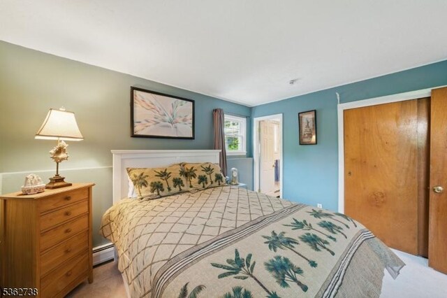 19 Paderewski Rd, Jefferson Twp, NJ 07438 - bedroom with a baseboard radiator, a closet, and light carpet