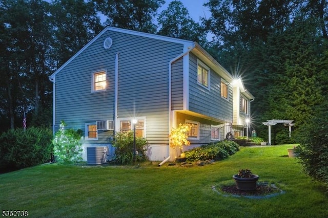19 Paderewski Rd, Jefferson Twp, NJ 07438 - view of property exterior featuring a yard, central air condition unit, a fire pit, and cooling unit