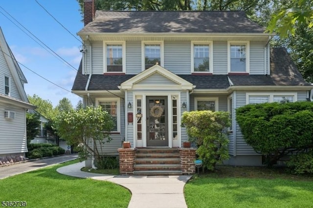 174 Garfield Pl, Maplewood Twp, NJ 07040 - view of front of property with a front lawn, a chimney, and roof with shingles