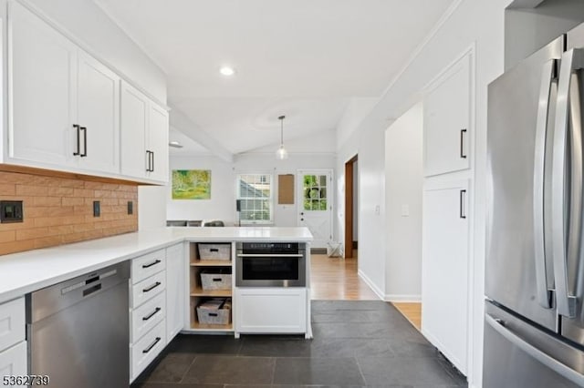 174 Garfield Pl, Maplewood Twp, NJ 07040 - kitchen with stainless steel appliances, tasteful backsplash, vaulted ceiling, white cabinets, and a peninsula