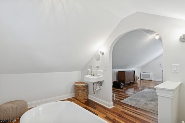 174 Garfield Pl, Maplewood Twp, NJ 07040 - bathroom with vaulted ceiling, a freestanding bath, wood finished floors, baseboards, and a wall mounted AC