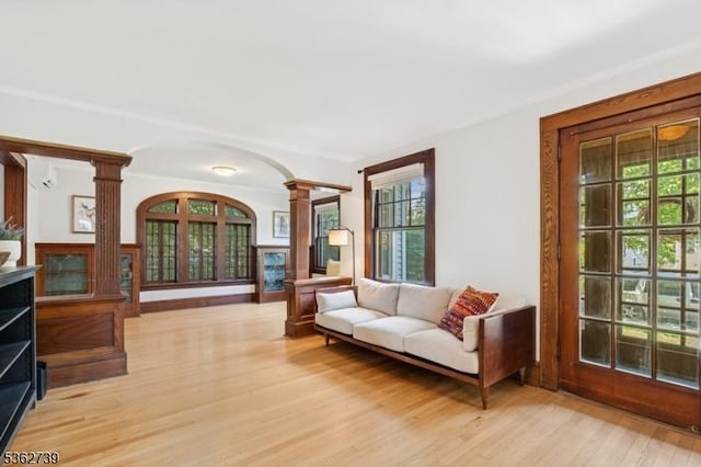 174 Garfield Pl, Maplewood Twp, NJ 07040 - living room featuring ornate columns, arched walkways, and light wood finished floors