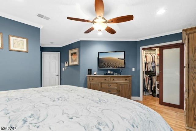3607 Park Pl, Springfield Twp, NJ 07081 - bedroom featuring light wood finished floors, a walk in closet, a closet, crown molding, and ceiling fan
