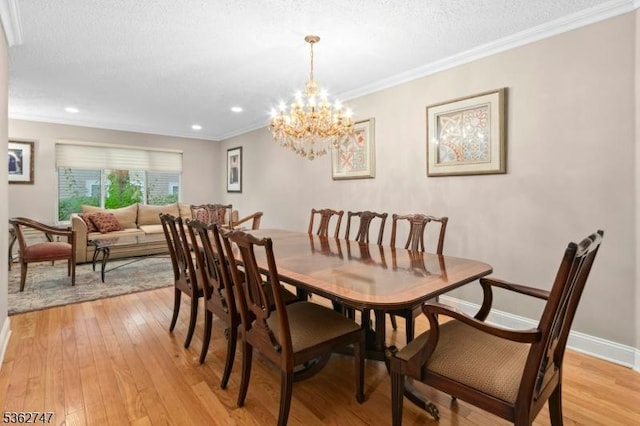 3607 Park Pl, Springfield Twp, NJ 07081 - dining room featuring light wood-style floors, a chandelier, ornamental molding, a textured ceiling, and recessed lighting