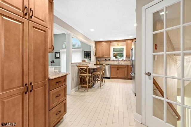 3607 Park Pl, Springfield Twp, NJ 07081 - kitchen with brown cabinets, stainless steel appliances, plenty of natural light, light stone countertops, and recessed lighting