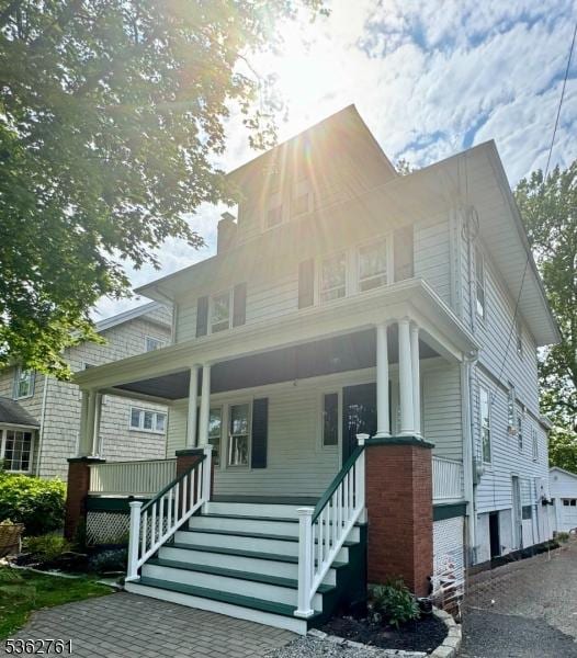 30 Hillcrest Ter, Verona Twp, NJ 07044 - view of front facade featuring a porch, stairs, and a chimney