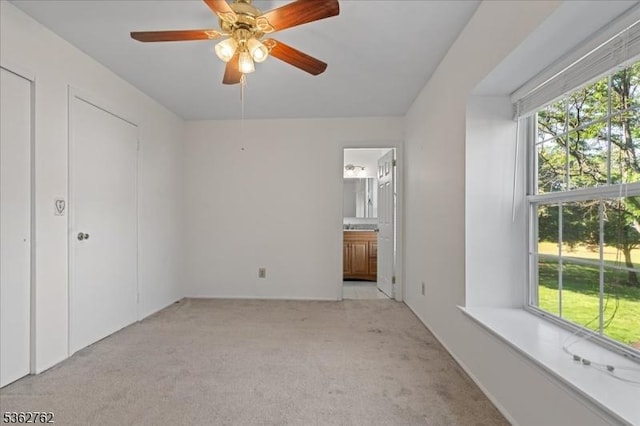 450 Saint Giles Ct, Franklin Twp, NJ 08873 - unfurnished bedroom featuring multiple windows, carpet flooring, connected bathroom, and a ceiling fan