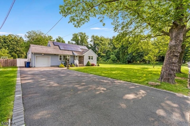 128 Parkside Rd, Plainfield City, NJ 07060 - view of front of home with asphalt driveway, an attached garage, and solar panels