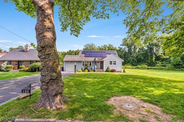 128 Parkside Rd, Plainfield City, NJ 07060 - ranch-style house with asphalt driveway, a garage, roof mounted solar panels, and a front yard