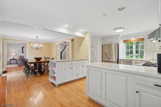 88 Pomeroy Rd, Madison Boro, NJ 07940 - kitchen featuring stainless steel appliances, white cabinetry, light countertops, light wood finished floors, and crown molding